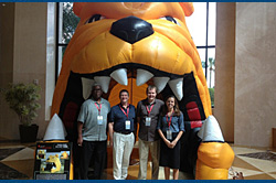Standing in the jaws of a CABMA Bulldog are IMG members (left to right) Earl Reed, Royal Coach Tours, Larry Stough, The Free Enterprise System, Michael Giddens, Pacific Coachways and Julie Chalmers, Calco Travel/Hotard Coaches. Standing in the jaws of a CABMA Bulldog are IMG members (left to right) Earl Reed, Royal Coach Tours, Larry Stough, The Free Enterprise System, Michael Giddens, Pacific Coachways and Julie Chalmers, Calco Travel/Hotard Coaches.