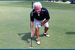The late Larry Benjamin retrieves his ball from a hole in one! The late Larry Benjamin retrieves his ball from a hole in one!