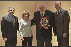 Joseph Edraney (right, center) receives 45-year Safe Driver Award presented by President, Tom JeBran (left), Founder, Camille JeBran (left, center) and Senior Vice President, Kirby Parnell (right).
